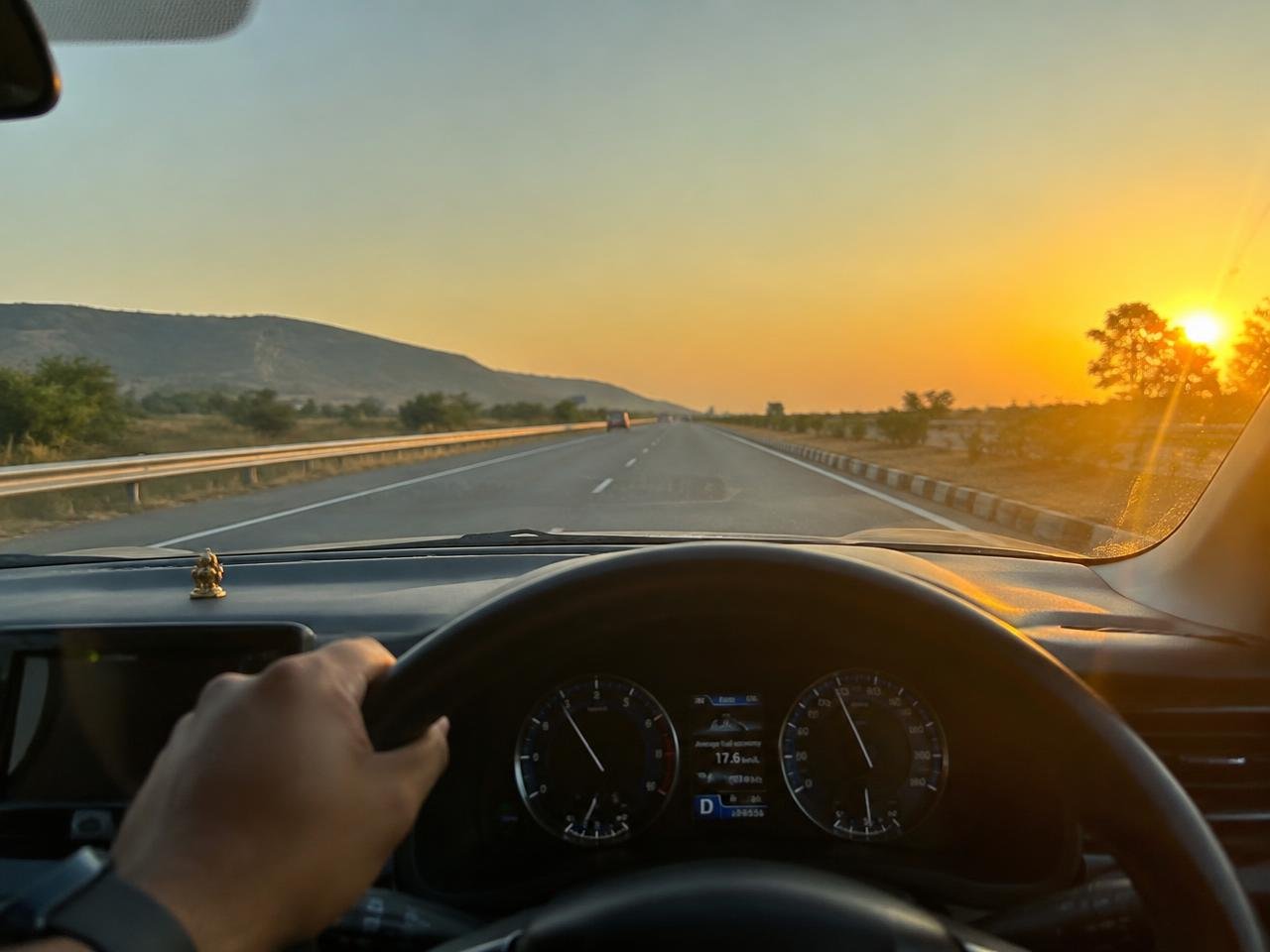 Driver at the wheel on an Indian national highway at golden hour